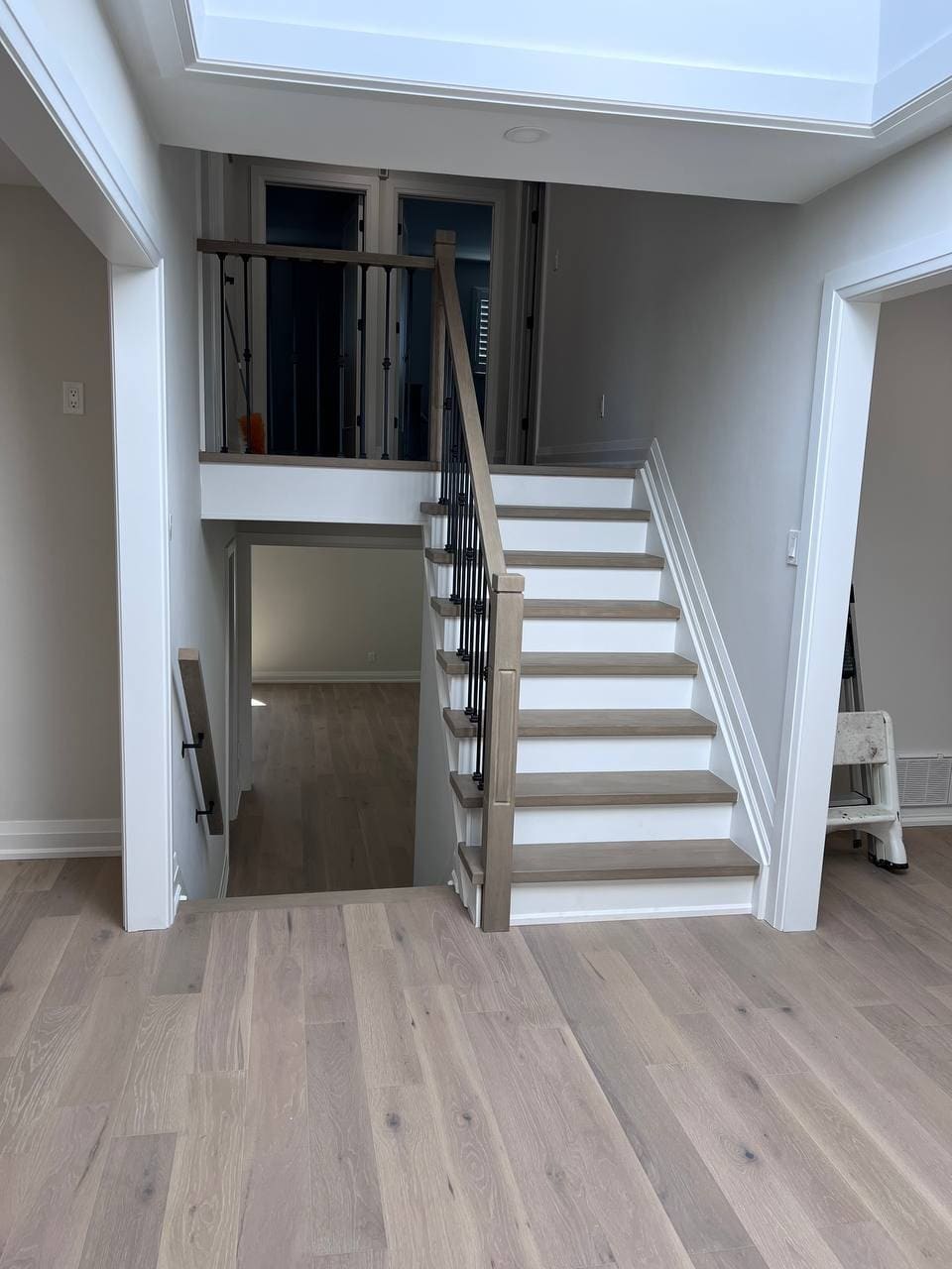 Renovated interior with a refinished staircase, iron spindles and white oak flooring