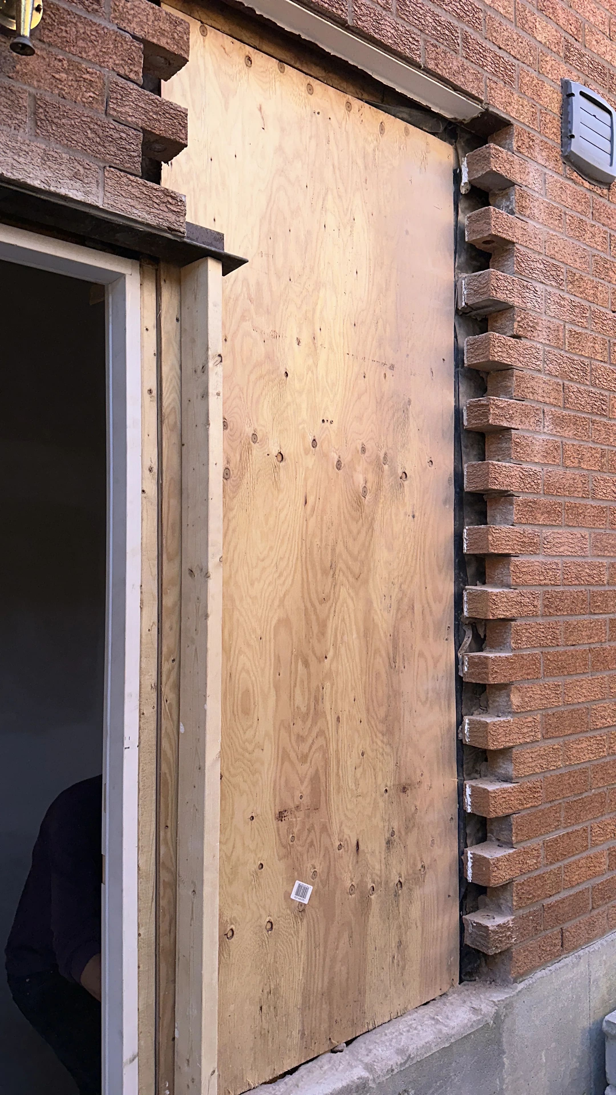 Exterior wall renovation in progress with brick removed,