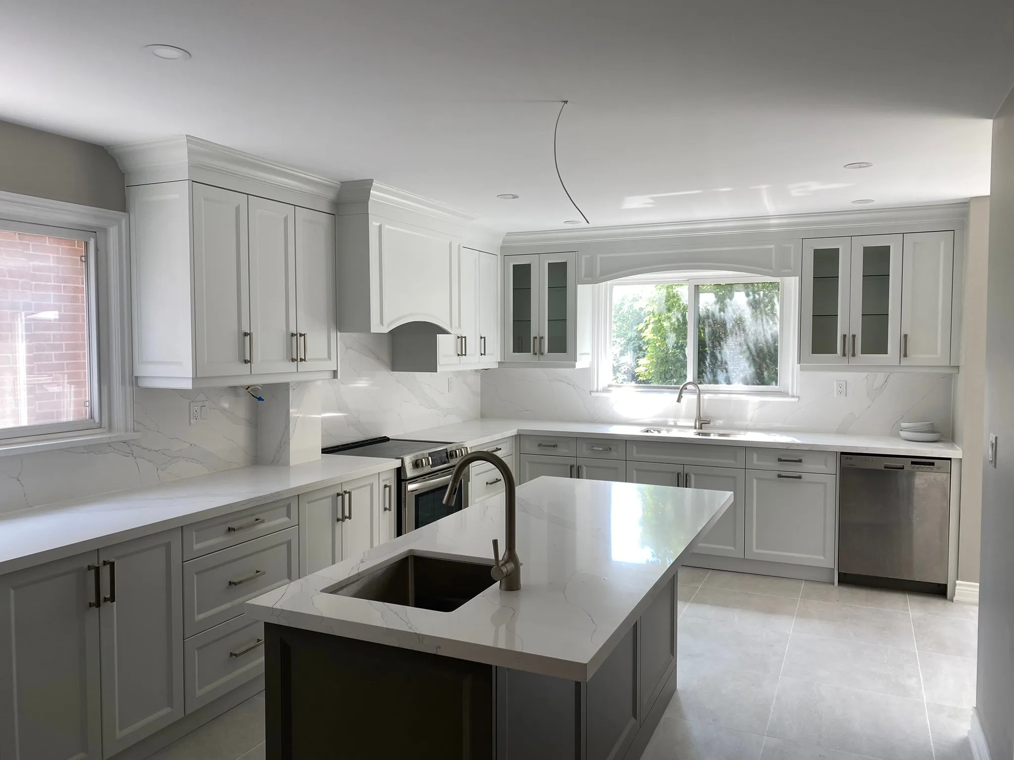 Completed modern white kitchen renovation with quartz